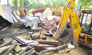 Encroachments being removed on the Ambala-Jagadhri road near Khudda village in Ambala on Wednesday.