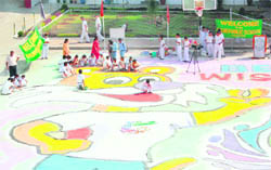 Students of Delhi Public School make rangoli in Jammu on Wednesday to wish luck to participants of the Commonwealth Games.