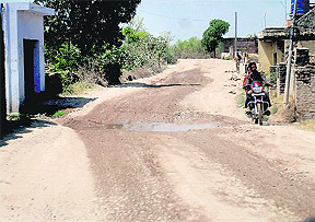A view of the potholed road in Ropar district. 