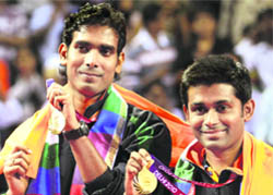 Sharath Kamal Achanta (L) and Subhajit Saha hold their gold medals during the medal ceremony after the table tennis mens doubles final.
