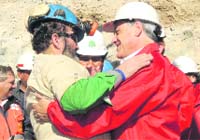 Chiles President Sebastian Pinera (R) with a miner