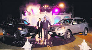 MD & CEO, Hyundai Motor India Ltd, H W Park (left) and Director, Marketing & Sales, Arvind Saxena with the company's new luxury SUV Santa Fe during its launch at a village in Jodhpur. Its basic model is priced at Rs 20.95 lakh