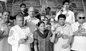 BJP leaders show samples of rotten wheat during an exhibition at Sector 5, Panchkula, on Thursday. 