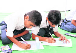 Students participate in an essay-writing contest in Dehradun on Wednesday. 
