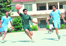 Players in action at the First Boys Basketball SGRR Sahodaya Complex Tournament in Dehradun on Thursday.