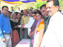 Cabinet Minister Madan Kaushik presents cheques to victims of disaster 