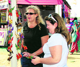These foreign nationals have a close look at Indian handicrafts during Sheetla Saras Fair.