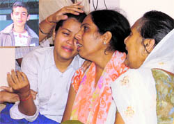 The wailing sister (left) and mother (centre) of Rajit (inset), who was killed in an accident in Ludhiana on Thursday