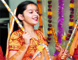 A girl participates in dandia during Navratra celebrations at Green Land Senior Secondary Public School