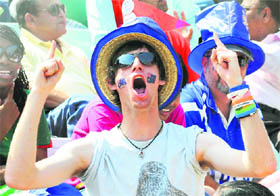 An Australian supporter celebrates his teams victory over India in the final of the mens hockey event in New Delhi on Thursday. 