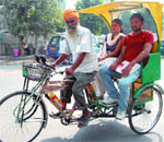 Jasbir Singh plies his new eco-friendly rickshaw in Amritsar.