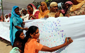 Women participating in a signature campaign in support of their demands to mark the World Rural Women's Day in Bathinda on Friday.