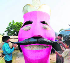 Aftaab Arif (left) and Rahisuddin prepare the effigy of Ravana in Chandigarh on Friday.