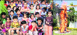 Students of Poly Kids school watch an effigy of Ravana (right) in flames on their school premises in Dehradun