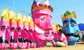 An artist prepares the effigies of Ravana and Kumbhkarana for Dasehrain Dharamsala on Friday.