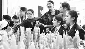 Schoolchildren sell self-made candles in Shimla on Friday. 