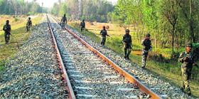 Securitymen keep a vigil along a railway line in Srinagar. Rail services between Qazigund and Baramulla have been suspended for the past more than two months in the wake of unrest in the Valley. 