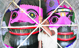 An artist gives final touches to the hi-tech effigy of Ravana at Dugri in Ludhiana.