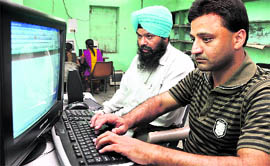 Ashok Kumar and Khushdev Singh take lessons in computers through a special talking software at the VRTC in Ludhiana.