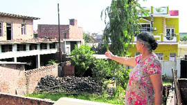 A resident points towards a factory operating in a residential area in Morinda.