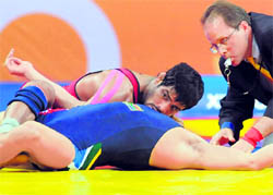 India's Sushil Kumar (top) competes against South Africa's Heinrich Barnes during the men's 66 kg freestyle wrestling finals. Sushil won gold