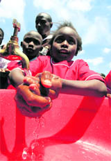 A girl washes her hands during an activity to mark Global Handwashing Day at a primary school near Nairobi on Friday. As many as 19,352 kids took part in the event in an attempt to break the Guinness World Record for the most number of people washing hands at a single venue.