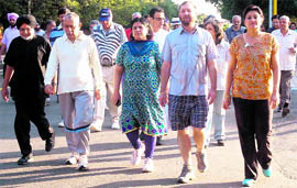People take part in a heritage walk from Sukhna Lake to Le Corbusier Centre in Sector 19, Chandigarh, on Saturday