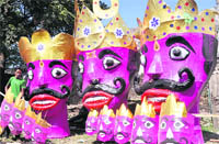 An artist gives final touches to the effigies of Ravana, Kumbhakarna and Meghnad in Dehradun. 