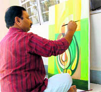 An artist works on his painting at an arts workshop in Pitthoragarh on Saturday