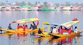 Tourists enjoy shikara rides in the Dal lake in Srinagar on Saturday as curfew restrictions were lifted.