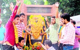Students pay tributes to martyrs at Government Gandhi Memorial Science College in Jammu on Saturday.