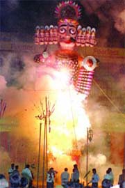 An effigy of Ravana set on fire by Prime Minister Manmohan Singh, UPA chief Sonia Gandhi and Congress general secretary Rahul Gandhi at the Ramlila Ground