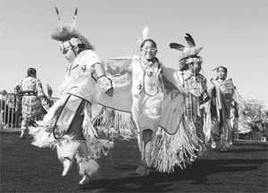 Native American children, perform on the newly-opened Mike O'Callaghan-Pat Tillman Memorial Bridge, which spans the Colorado River, beside the Hoover Dam. While this bridge is an exception, overall, infrastructure spending is being shelved in the US