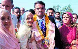 Vijay Kumar with his grandmother, mother and other family members in his ancestral Harsour village, Hamirpur, on Sunday.