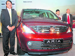 Tata Motors Utility Vehicles chief SG Saxena (left) at the launch of the companys new crossover car Aria in New Delhi on Monday. The car has been launched in three variants with the 4x4 drive Aria Pride, followed by the Aria Prestige and the Aria Pleasure. The car is priced between Rs 12.91 lakh and Rs 15.50 lakh (ex-showroom, Delhi). It comes with 2.2 litre direct injection common rail (DICOR) engine and is Bharat Stage-IV compliant. Tata Motors plans to roll out a new SUV and a pickup truck on the 2x2 platform by fiscal 2012.