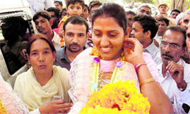 Commonwealth Games discus throw gold medallist Krishna Poonia with her family and friends at her hometown, Agroha.