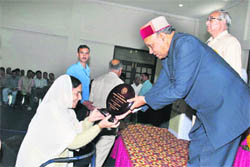 Chief Minister PK Dhumal honours a woman during the silver jubilee function of Rotary Eye Hospital at Maranda on Monday.