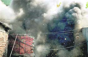 Smoke fills the sky after the bomb disposal squad defused an improvised explosive device near the police control room in Srinagar