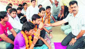 Science college students take juice to break their fast on the college campus in Jammu
