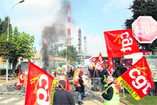 Workers block the entrance of the Grandpuits refinery near Paris on Monday. 