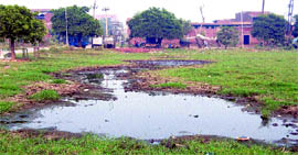 A pool of dirty water (top) and a view of kutcha road inside the Focal Point in Amritsar.