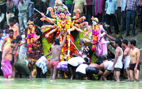 Devotees immerse an idol of Goddess Durga in a river in Amritsar.