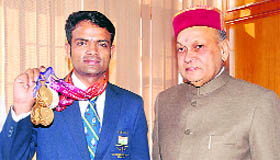 CWG gold medallist Vijay Kumar flaunts his medals with Chief Minister PK Dhumal in Shimla on Tuesday.