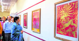 Manisha Nanda, Principal Secretary, Tourism, observes the works of artist Prabal Pramanik during the paper cutting art exhibition in Shimla on Tuesday.