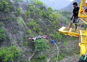 A man performs bungee jumping at a camp organised by the Uttarakhand Tourism Department at Mohanchatti, near Rishikesh