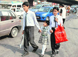 Students walk to their school in Srinagar on Wednesday
