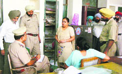 Police officials record the statement of education department officials after a theft in Ludhiana