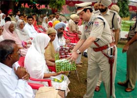 DIG Bathinda range, Lok Nath Angra, distributing souvenirs to kin of police martyrs during the Commemoration Day ceremony held at Police Lines in Bathinda