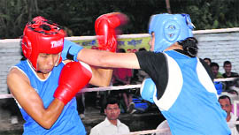 Pugilists clash at 11th Uttarakhand State Sub-Junior Boys and Senior Girls Boxing Championship at the Parade Ground in Dehradun on Thursday.