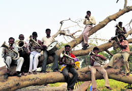 These band artistes perched on tree branches try to finetune a song in Faridabad